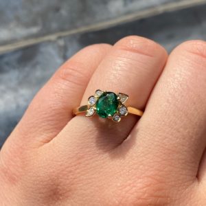 Emerald and diamond offset engagement ring