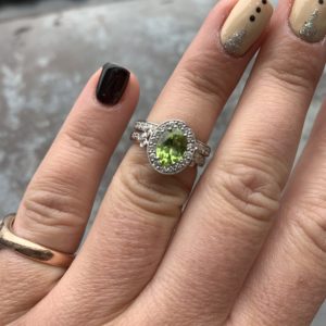 Peridot and diamond halo engagement ring with matching diamond wedding ring