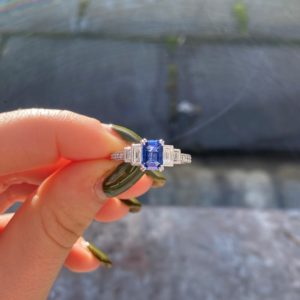 Emerlad cut sapphire and baguette diamond five gemstone ring