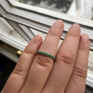 Platinum and emerald mill grain set wedding ring