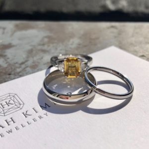 Yellow sapphire and diamond engagement ring with plain wedding ring